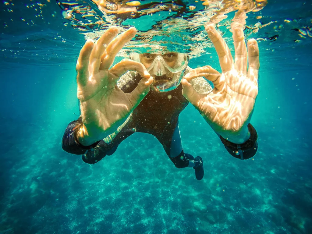 Happy diver giving the OK sign after successfully clearing their mask with Scorpion Dive in Sharm El Sheikh.