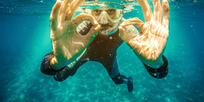 Happy diver giving the OK sign after successfully clearing their mask with Scorpion Dive in Sharm El Sheikh.